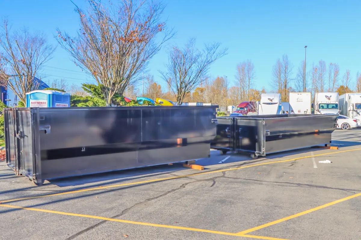 Professional dumpster rental service with roll-off container on residential driveway in Medfield